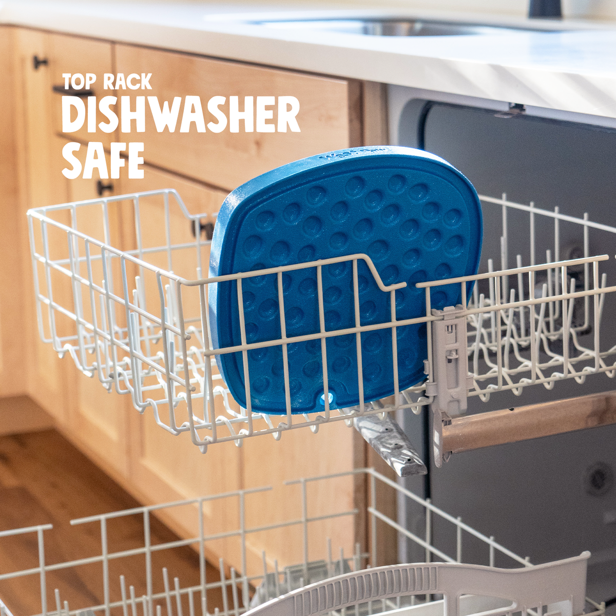 Blue West Paw Bubbles Feast Mat in a dishwasher top rack, with “Top Rack Dishwasher Safe” text.