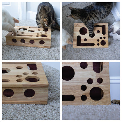 Two cats reaching through the openings of the Fig & Friends wooden enrichment box.