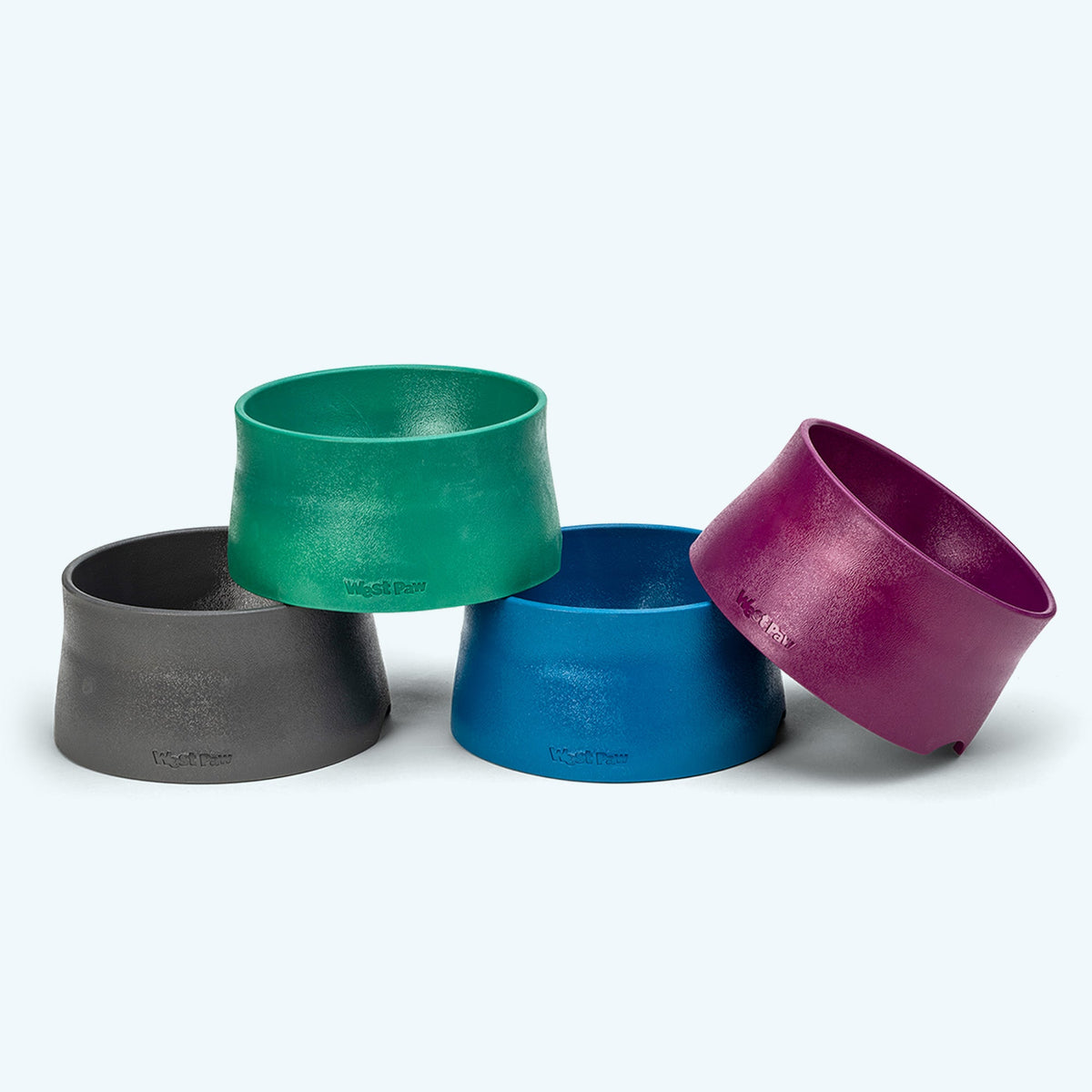Four West Paw Non-Slip dog bowls in gray, green, blue and purple