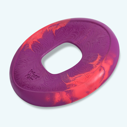 Red and purple West Paw Sailz fetch disc with a center opening